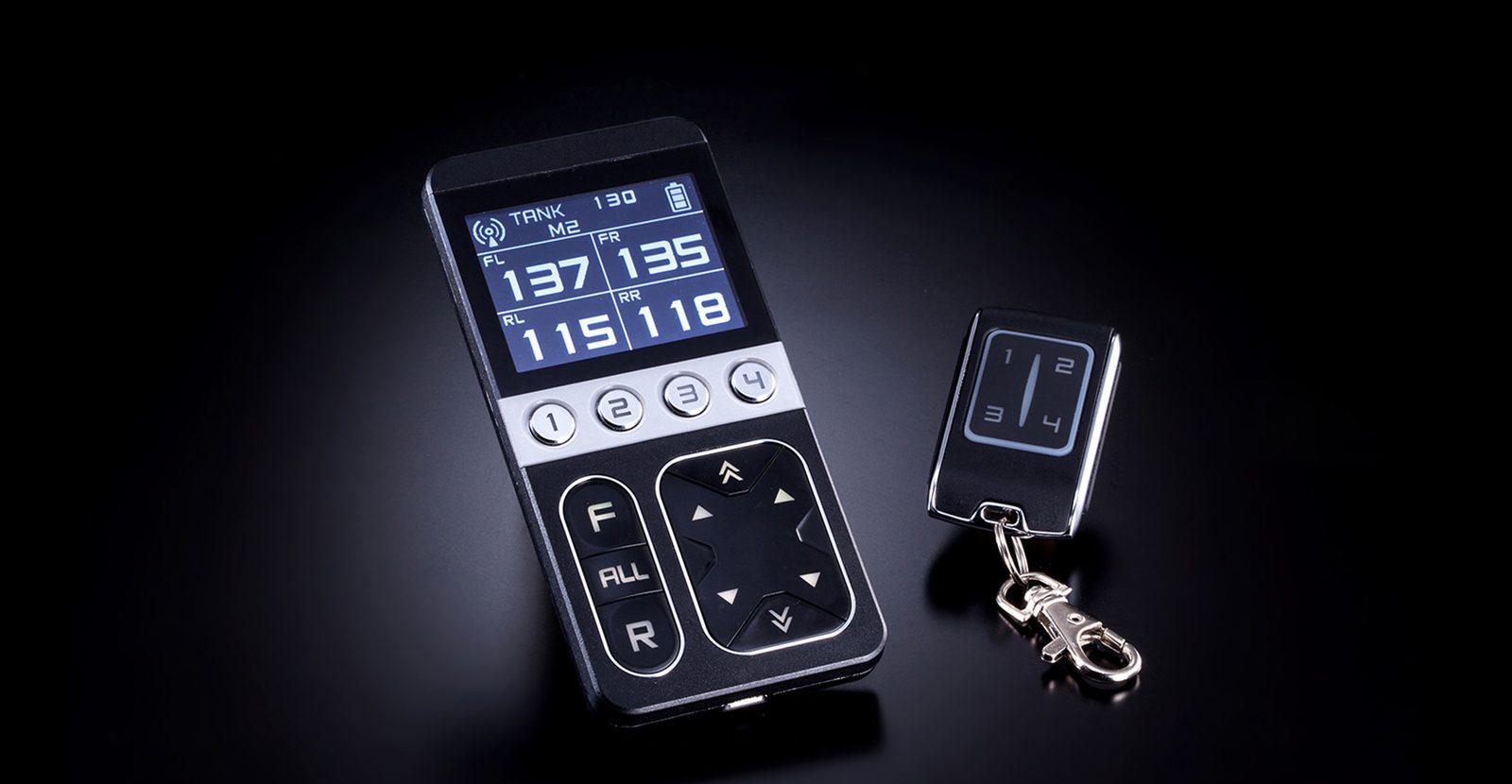 AirForce handset with its blue-white LCD showing four corner pressures, next to the key-fob remote